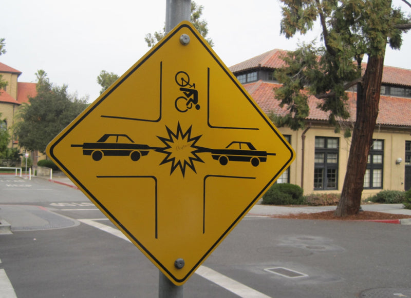 Żółty znak na słupie wskazujący obszar wyznaczony dla OC rowerzysty.